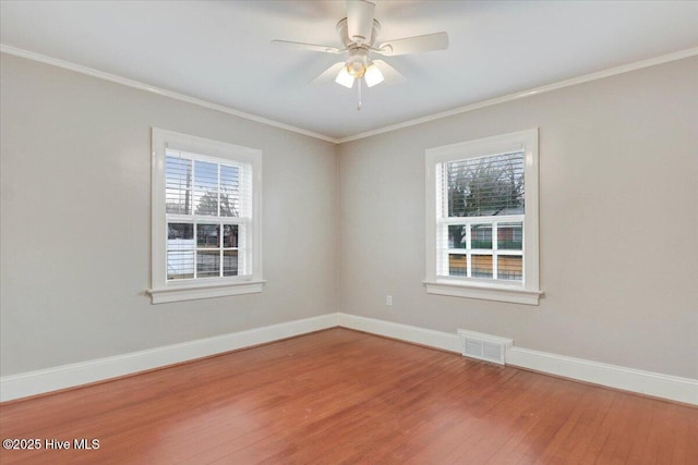 unfurnished room with hardwood / wood-style flooring, a wealth of natural light, ornamental molding, and ceiling fan