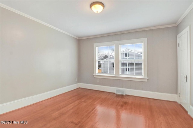 unfurnished room with hardwood / wood-style flooring and ornamental molding