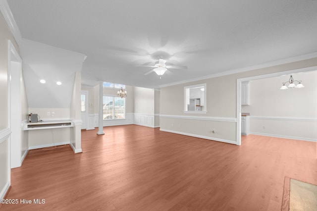 unfurnished living room with hardwood / wood-style flooring, ceiling fan with notable chandelier, and ornamental molding