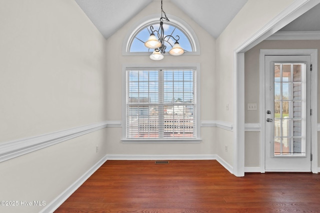 unfurnished dining area with dark wood-type flooring, lofted ceiling, and a notable chandelier