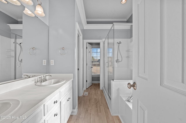 bathroom with crown molding, vanity, shower with separate bathtub, and hardwood / wood-style floors