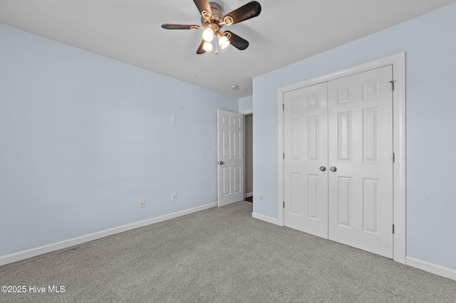 unfurnished bedroom featuring light carpet, a closet, and ceiling fan