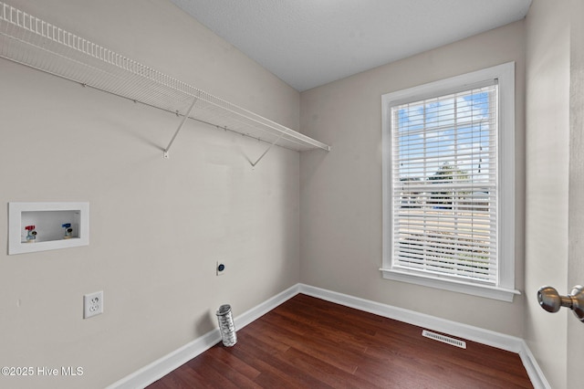 laundry area with hookup for a washing machine, hookup for an electric dryer, and dark hardwood / wood-style flooring