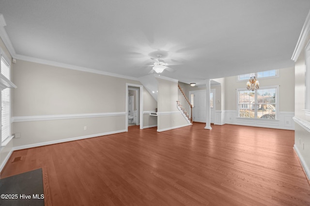 unfurnished living room with ornamental molding, wood-type flooring, and ceiling fan with notable chandelier