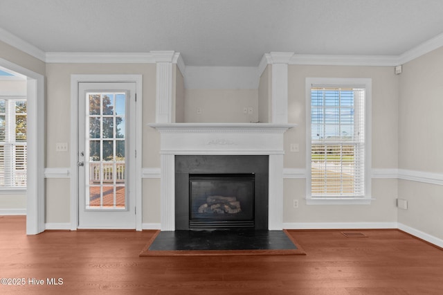 unfurnished living room featuring hardwood / wood-style flooring and ornamental molding