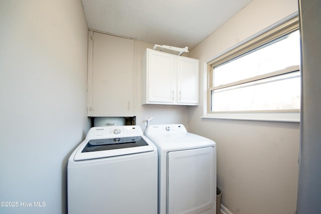 laundry room featuring cabinets and washing machine and clothes dryer