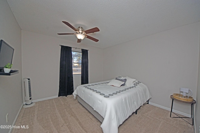 carpeted bedroom with ceiling fan and a textured ceiling