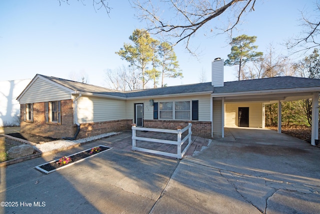 ranch-style house featuring a carport