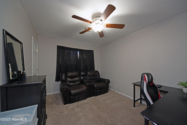 office space with ceiling fan, light colored carpet, and a textured ceiling