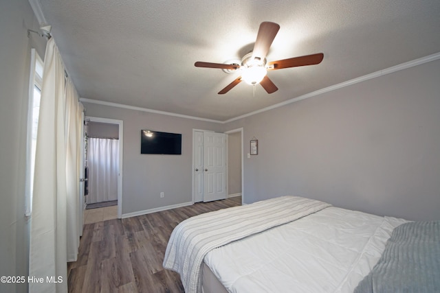 bedroom with crown molding, dark hardwood / wood-style flooring, and a textured ceiling