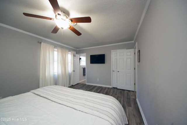 bedroom featuring ceiling fan, ornamental molding, dark hardwood / wood-style flooring, and a textured ceiling