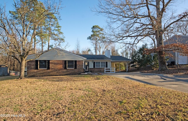 ranch-style house with a front lawn and a carport