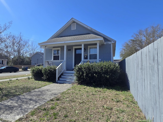 bungalow-style home featuring a porch and a front lawn