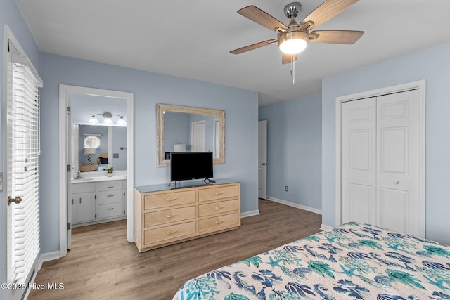 bedroom with connected bathroom, baseboards, light wood finished floors, and a closet