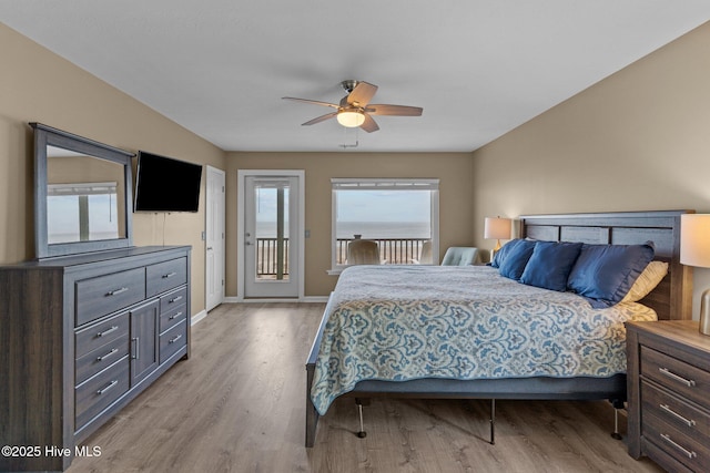 bedroom featuring light wood-type flooring, a ceiling fan, baseboards, and access to outside