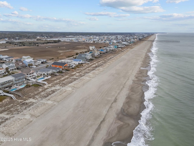 drone / aerial view with a residential view, a view of the beach, and a water view