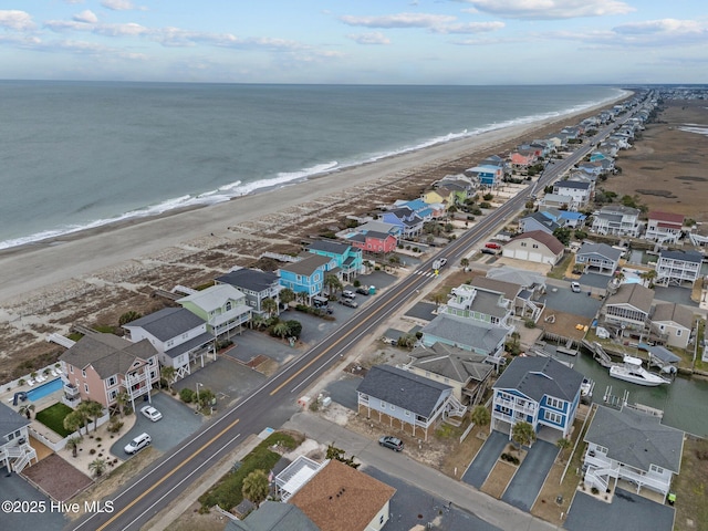 birds eye view of property featuring a residential view, a water view, and a beach view