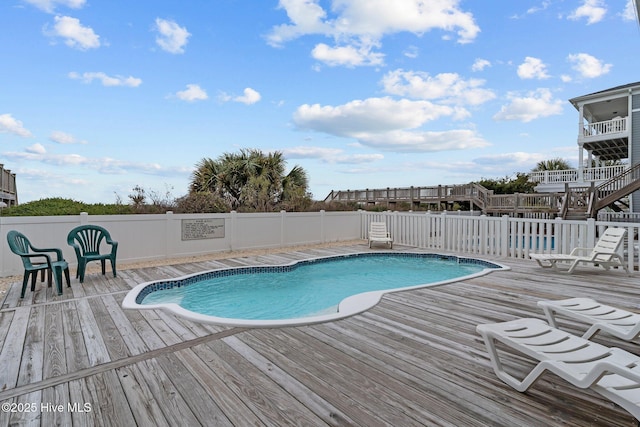 view of pool with fence, a wooden deck, and a fenced in pool