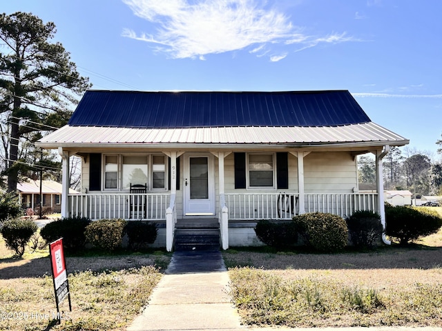 view of front of house with metal roof and a porch