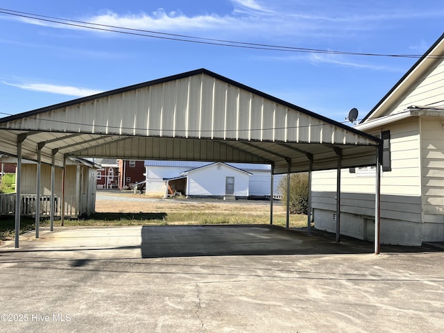 view of parking / parking lot with driveway and a carport