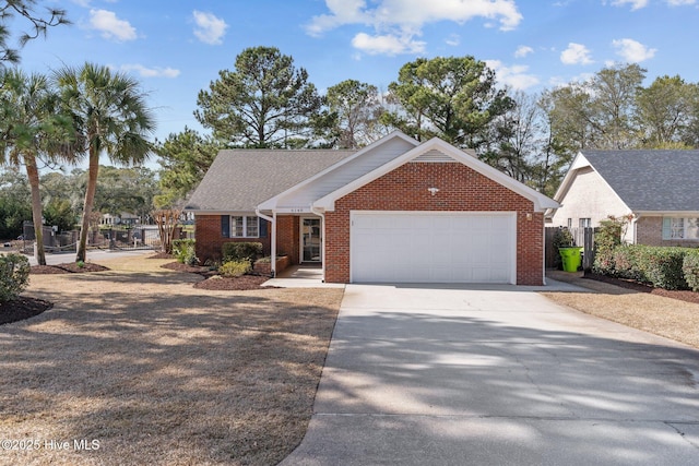 single story home featuring a garage, brick siding, driveway, and fence