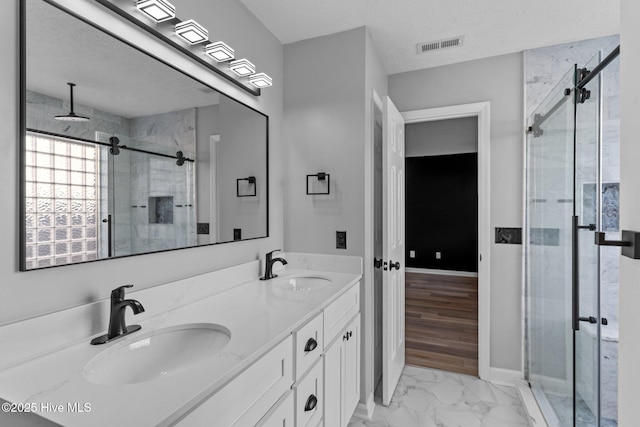 6148 Sugar Pine Dr, Wilmington, NC 28412 - bathroom with a shower stall, marble finish flooring, double vanity, and baseboards