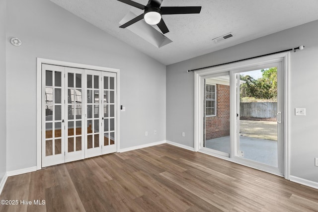 6148 Sugar Pine Dr, Wilmington, NC 28412 - spare room featuring wood finished floors, a ceiling fan, lofted ceiling, a textured ceiling, and baseboards