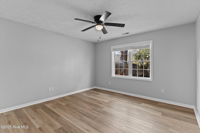 6148 Sugar Pine Dr, Wilmington, NC 28412 - empty room with wood finished floors, a textured ceiling, a ceiling fan, and baseboards