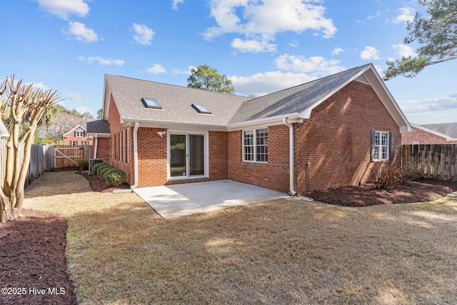 6148 Sugar Pine Dr, Wilmington, NC 28412 - back of house featuring brick siding, a patio, a shingled roof, and a gate