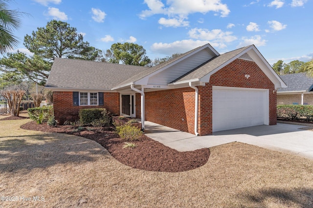 6148 Sugar Pine Dr, Wilmington, NC 28412 - ranch-style house featuring an attached garage, brick siding, driveway, and roof with shingles