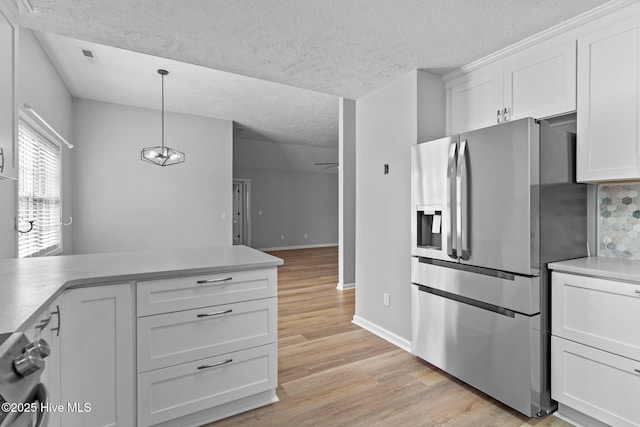6148 Sugar Pine Dr, Wilmington, NC 28412 - kitchen with stainless steel refrigerator with ice dispenser, white cabinets, light wood finished floors, a textured ceiling, and range