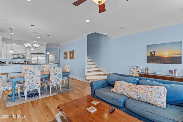 living room with ceiling fan, light hardwood / wood-style floors, crown molding, a fireplace, and built in features