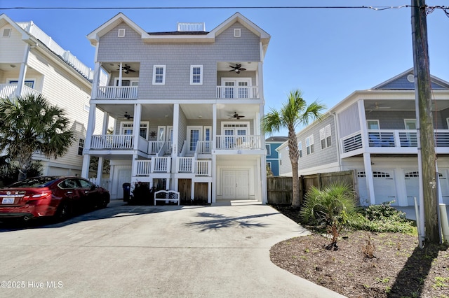 raised beach house with ceiling fan, covered porch, and a balcony