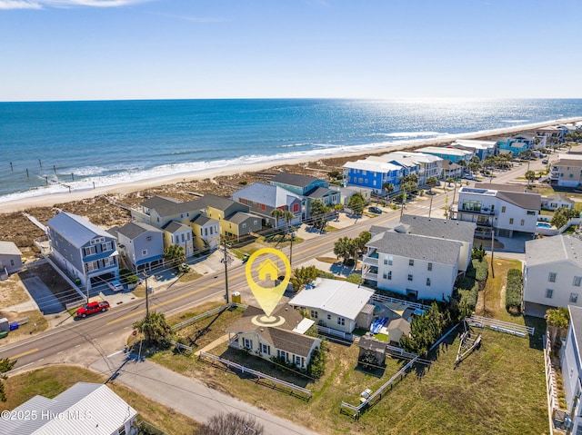 aerial view featuring a view of the beach, a residential view, and a water view