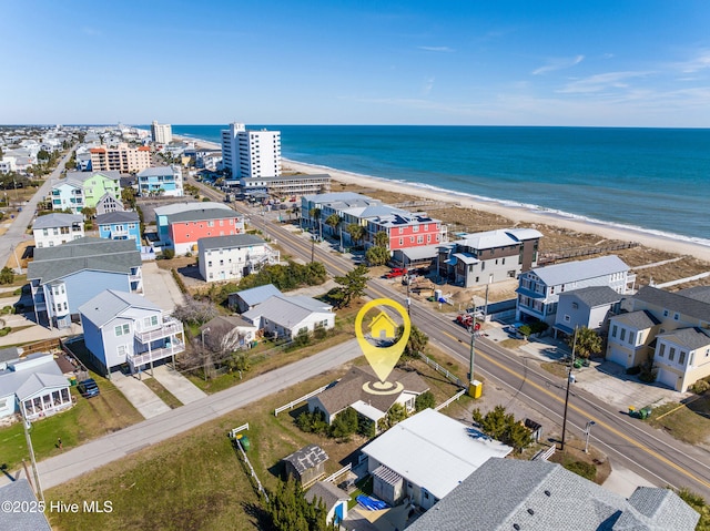 birds eye view of property with a beach view and a water view