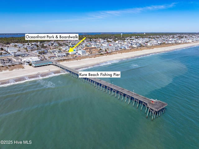 bird's eye view with a water view and a beach view