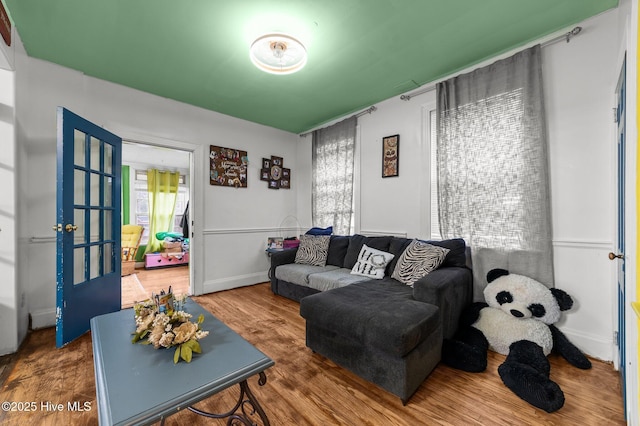 living room with baseboards and wood finished floors