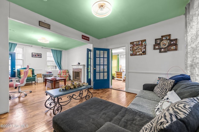 living room with a fireplace, wood finished floors, and baseboards