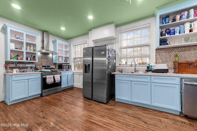 kitchen with stainless steel appliances, white cabinetry, light countertops, wall chimney range hood, and open shelves