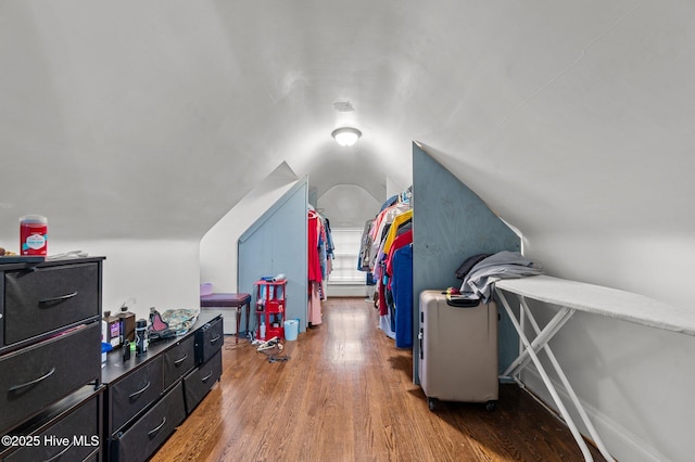 bedroom with vaulted ceiling and wood finished floors