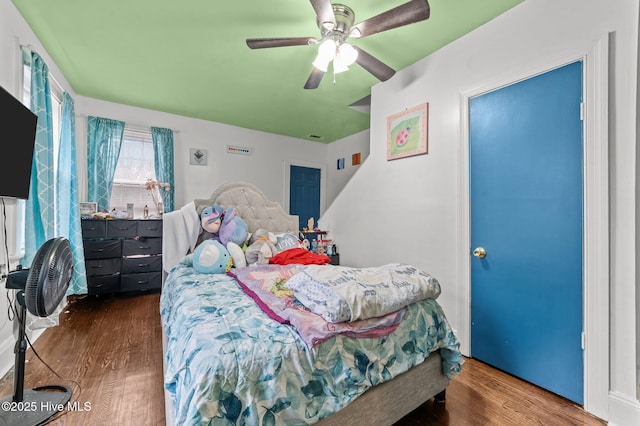 bedroom with ceiling fan and wood finished floors