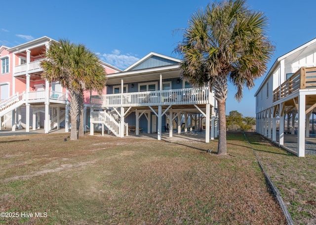 rear view of property with a yard