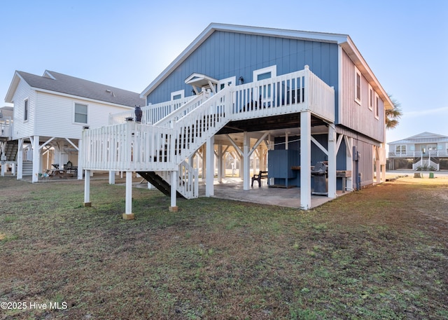 back of house featuring a patio, a yard, and a deck