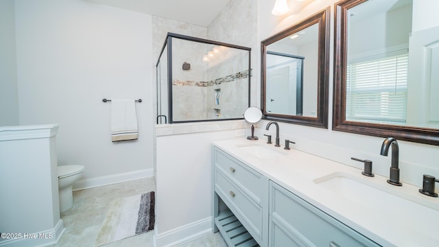 bathroom featuring walk in shower, vanity, and toilet