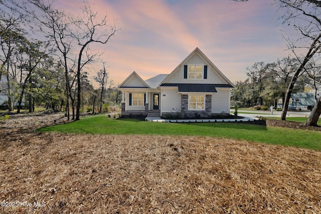 view of front of property featuring a front yard and stone siding