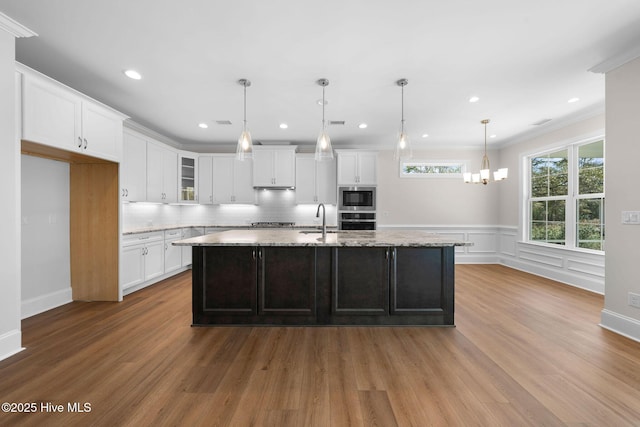 kitchen with dark brown cabinets, a ceiling fan, dishwasher, a sink, and a raised ceiling