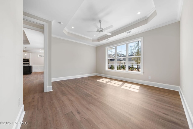 unfurnished living room featuring a stone fireplace, baseboards, built in features, crown molding, and wood finished floors