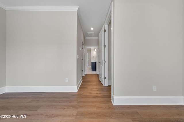 unfurnished room with a tray ceiling, wood finished floors, ceiling fan, and visible vents