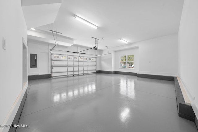 garage with a garage door opener, baseboards, and electric panel