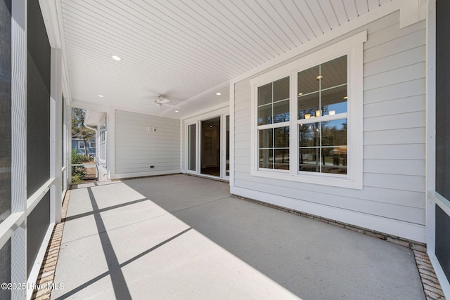 unfurnished sunroom featuring a ceiling fan